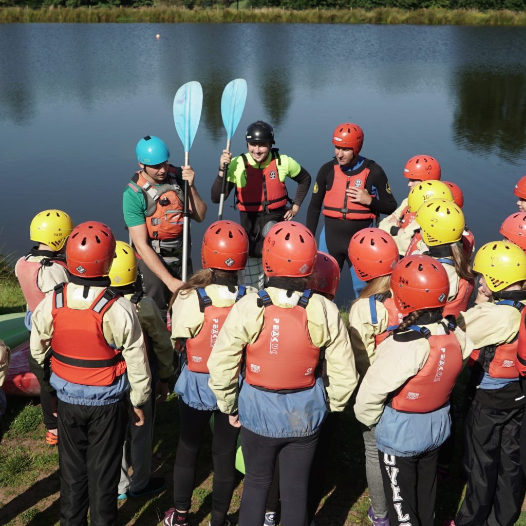 Group of children learning about water sports