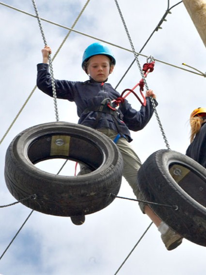 Boy on raised activity course